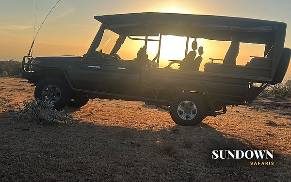 Sun setting behind the Land Cruiser after a game drive, Constellation 7 day private safari