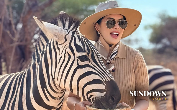 A Sundown Safaris guest meeting a zebra up close, Photographer 3 day private safari